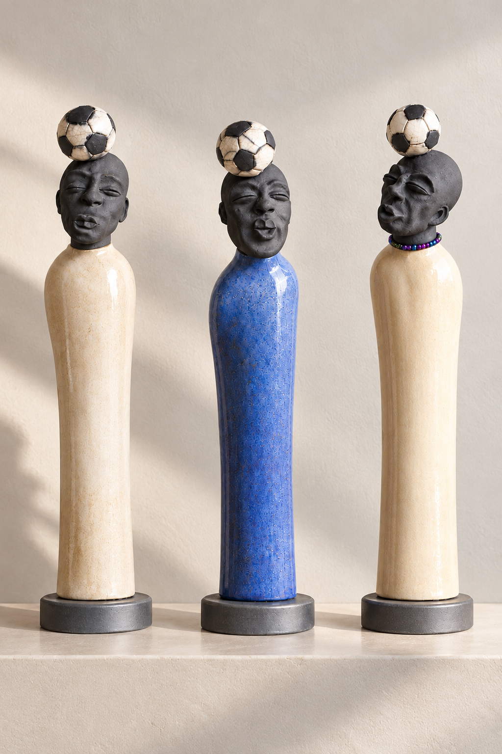 Ceramic clay sculptures with adornments on the head.