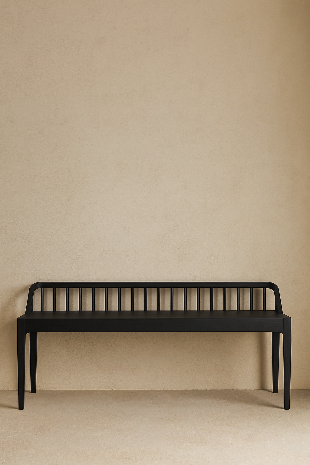 Black bench against a beige wall