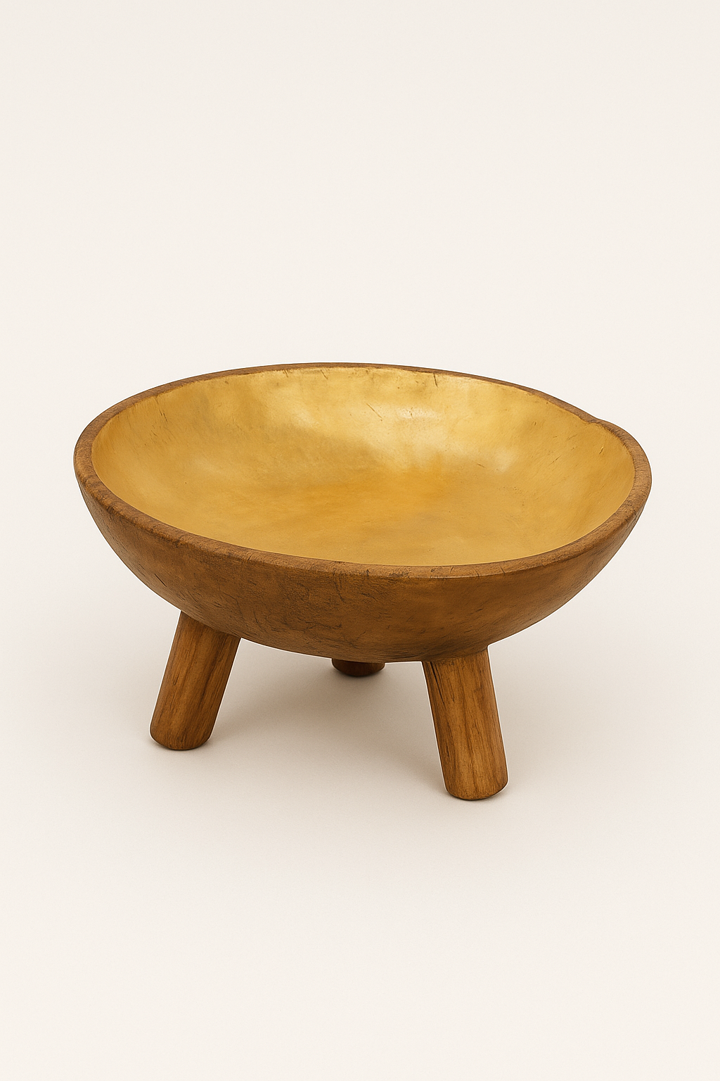 Hand-carved wooden tripod bowl with smooth golden interior and rustic finish, named Lekane