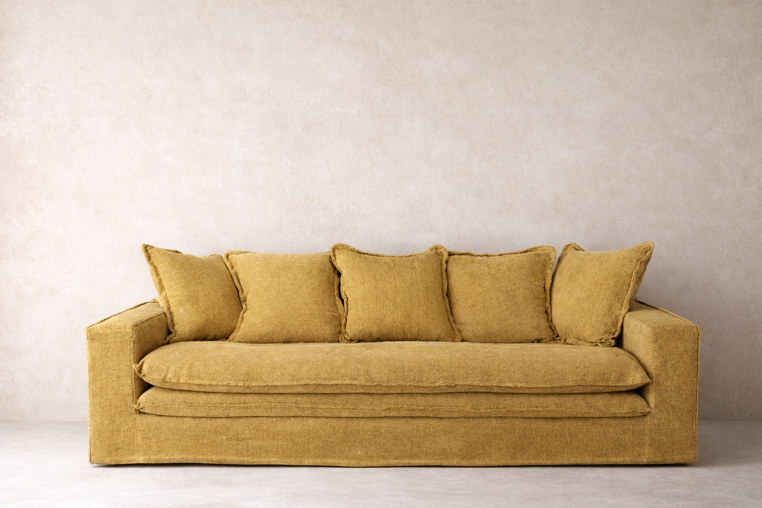 Wasini linen sofa in gold ochre with layered seat and structured silhouette.