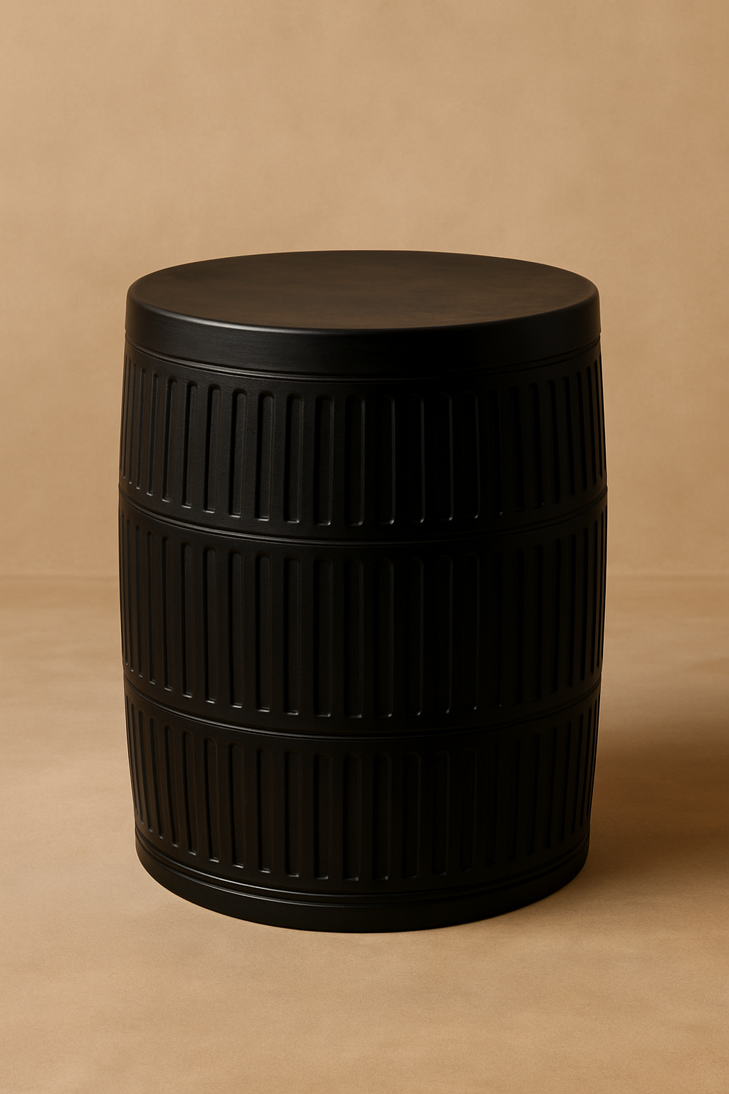 Yanis II Side Table in solid black-stained teak with barrel silhouette and carved vertical grooves, handcrafted accent table for luxury interiors and boutique hotels.

