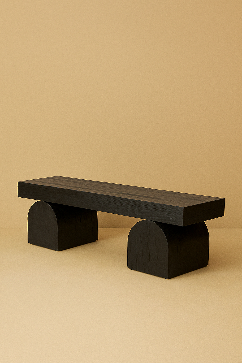 A black sculptural teak wood bench with curved pedestal legs, styled against a warm neutral wall